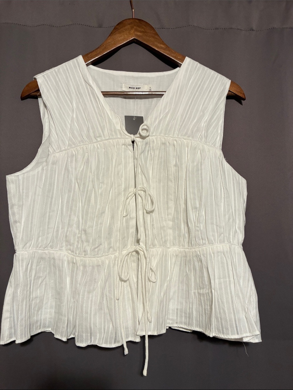 Mod Ref Cream Sleeveless Tie-Front Peplum Blouse